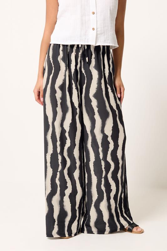 PixieGirl Petite Black Abstract Striped Wide Leg Trousers | PixieGirl 1